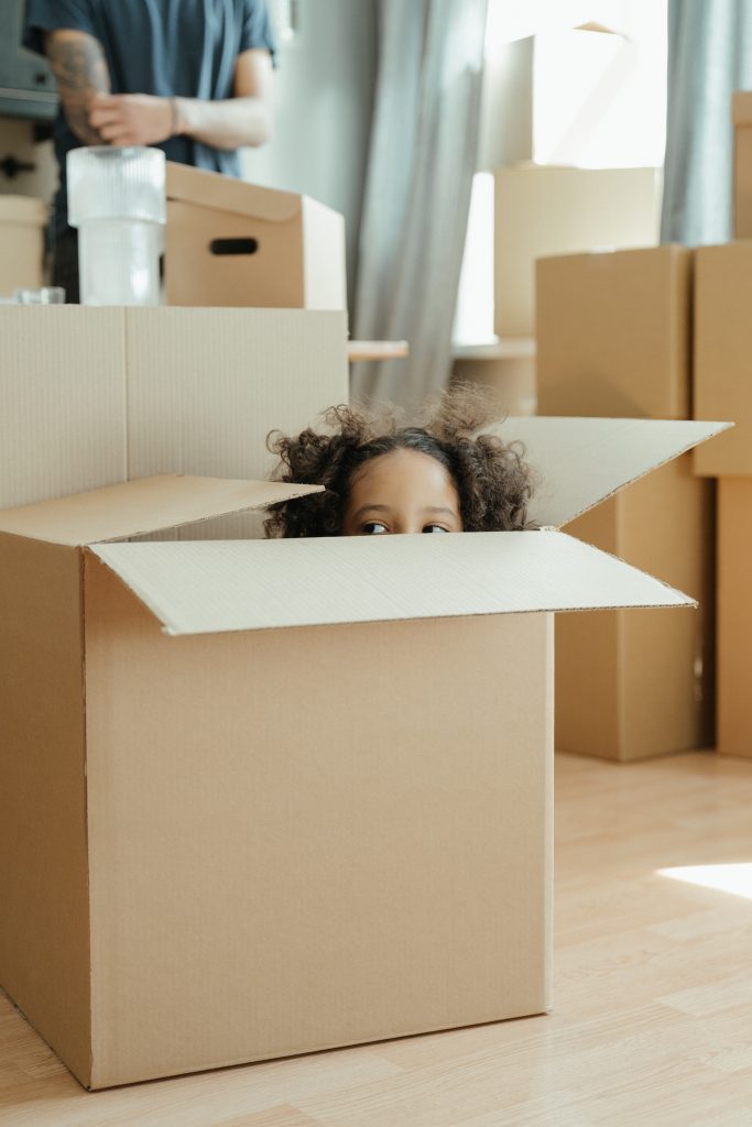 Girl peeping out of storage box