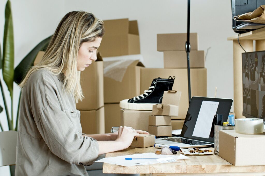 Business owner concentrating whilst packing products