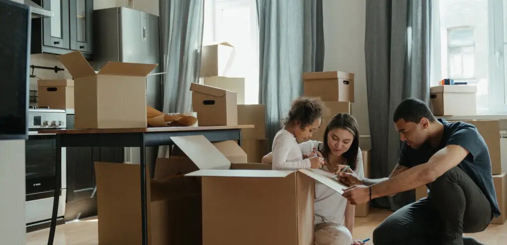 Couple With Child Packing boxes at home