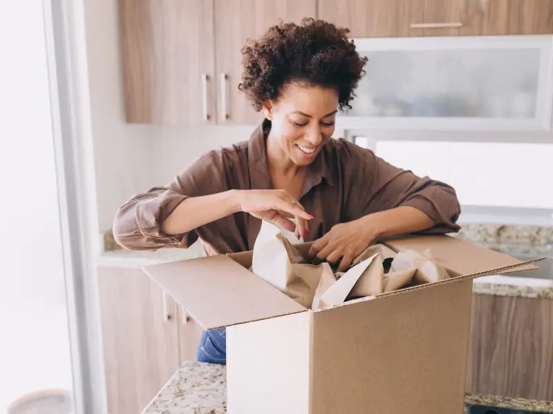 Woman packing items into storage box